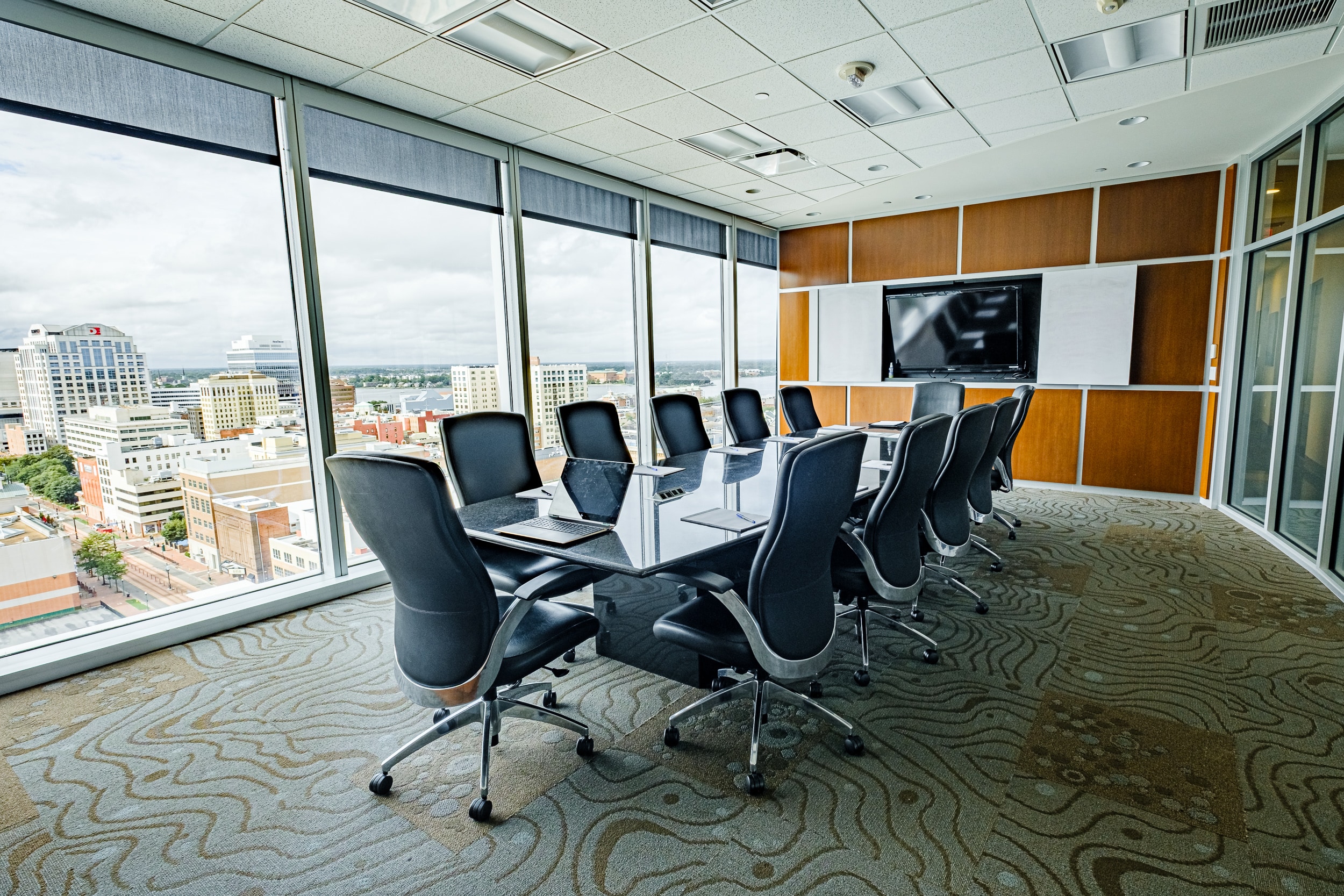 OSS Conference Room Wells Fargo Center. Full room view; displaying glass wall with beautiful view, modern decor and audio/visual wall.