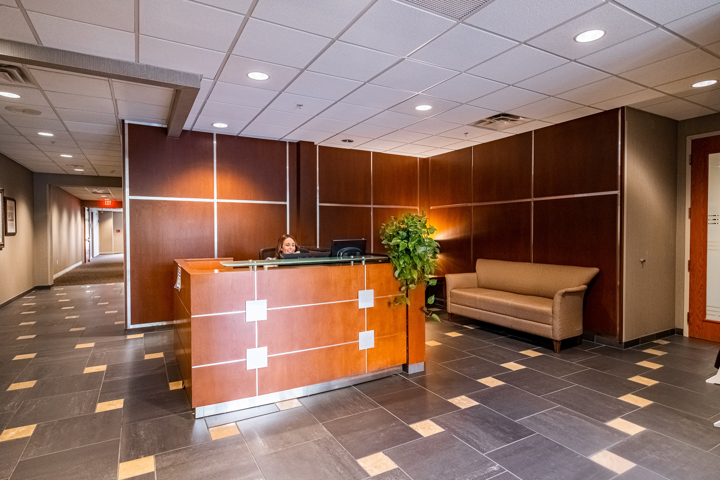 OSS Headquarters Lobby. Open and well-lit lobby, with stone floor and modern decor.