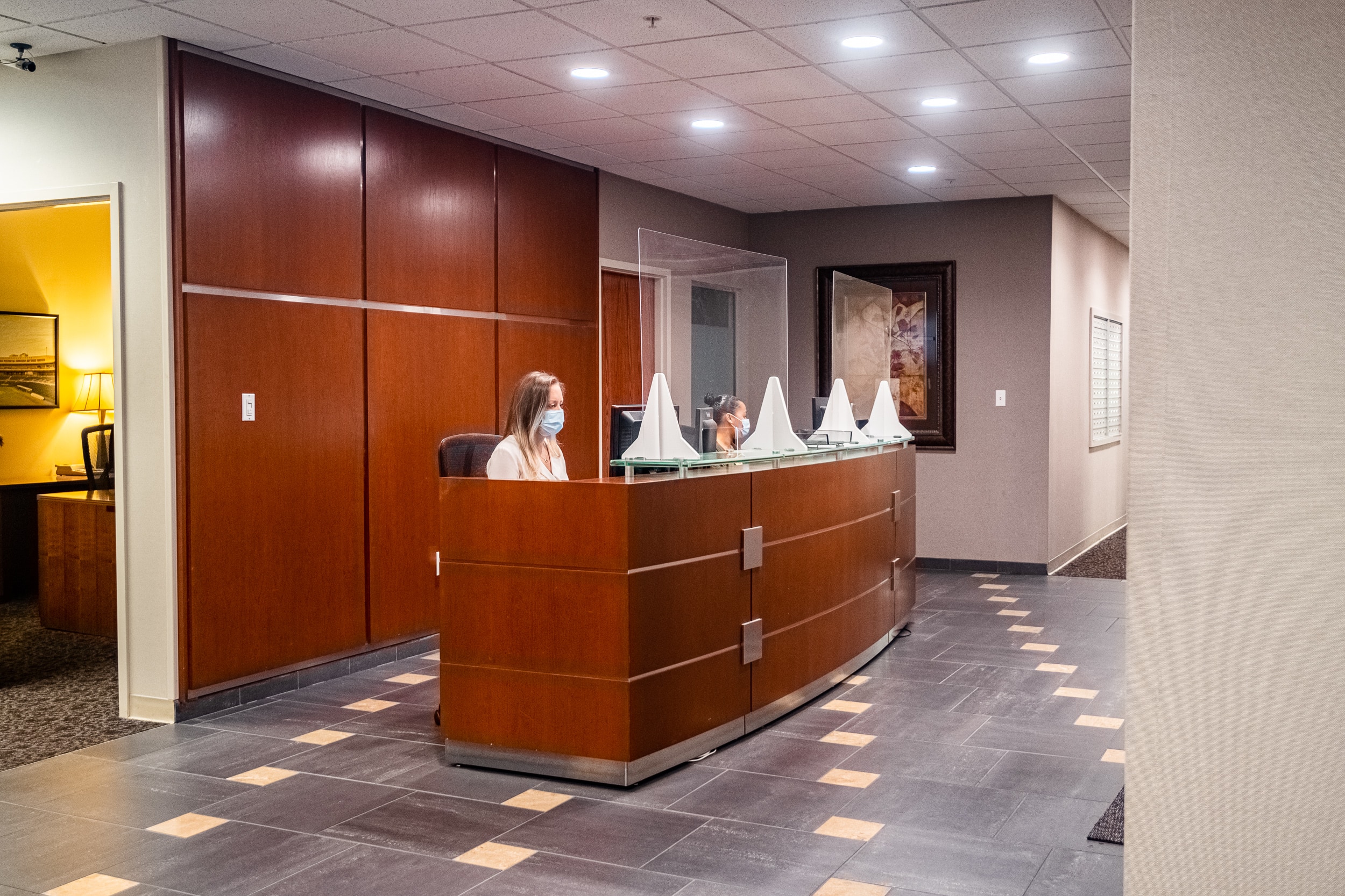 OSS Headquarters Virtual Receptionist. Receptionists greeting in the lobby of an office building.