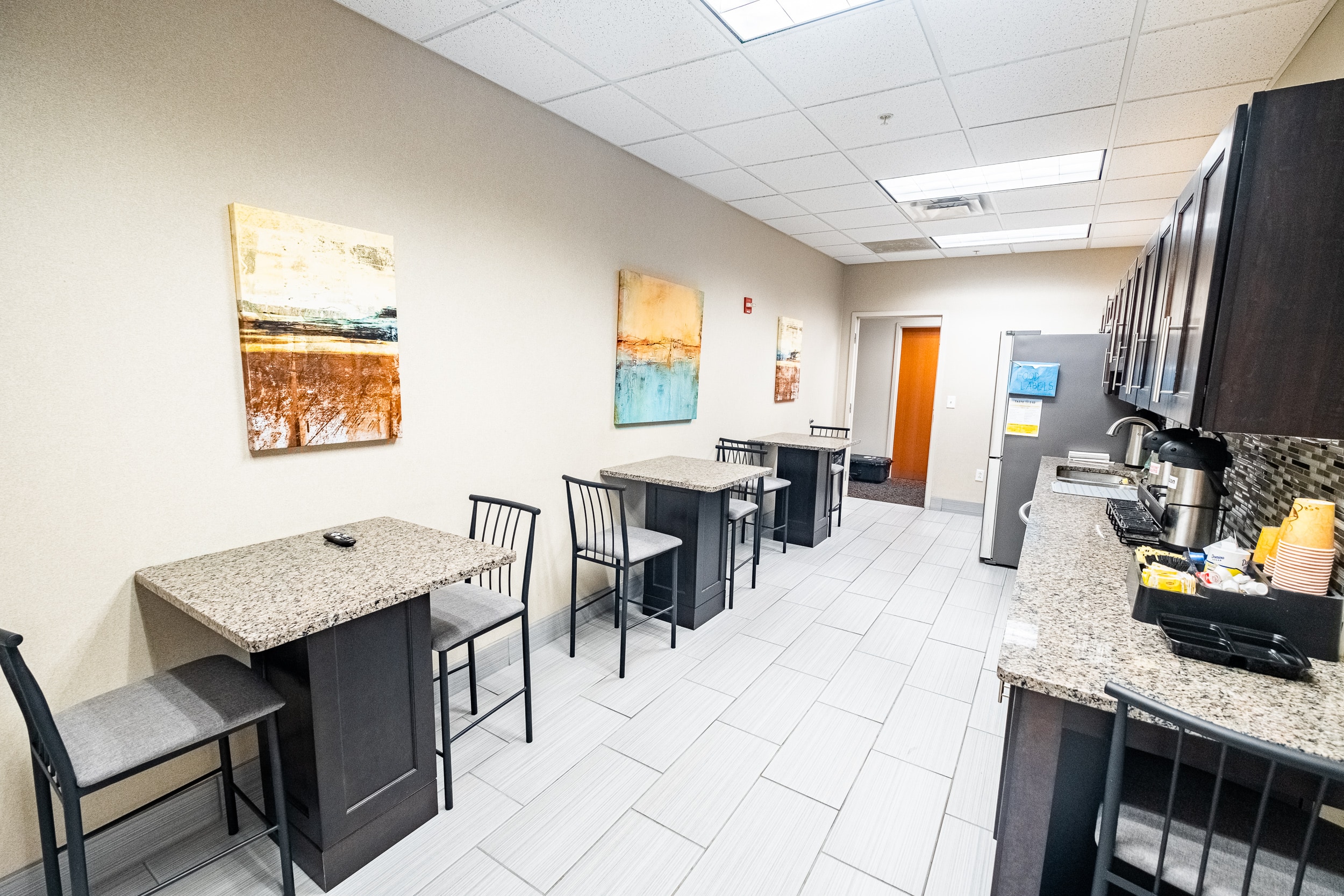 OSS Headquarters Kitchen. Common kitchen area; with several tables, chairs, sink and kitchenette.